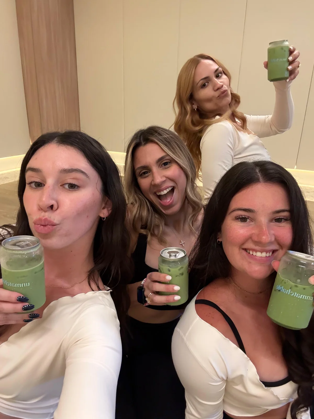 Friends raising their Unmatchable matcha drinks together